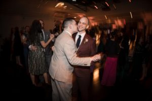 Two men dancing at a wedding reception in New York.