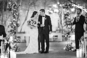 A bride and groom walk down the aisle at their New York wedding.