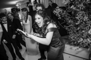 Black and white photo of a woman dancing at a wedding in New York.