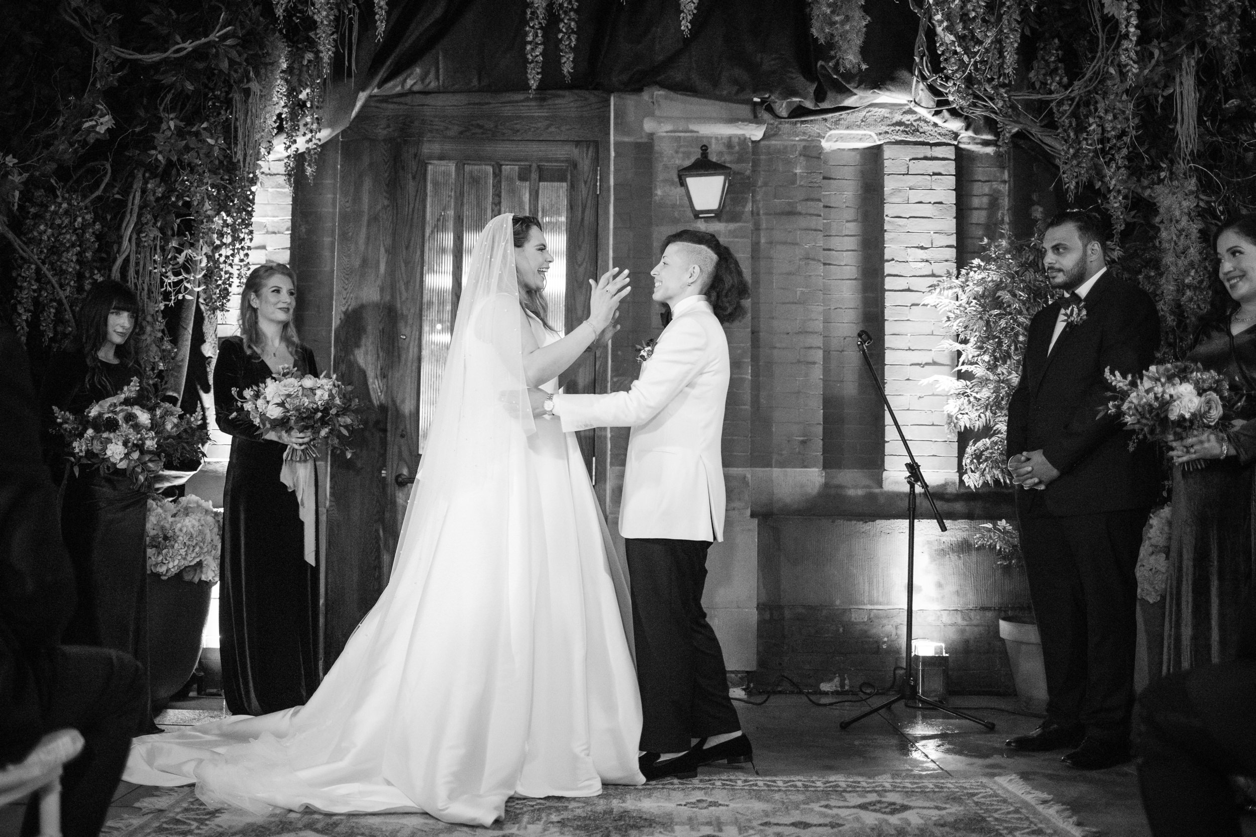 Two brides at the end of their ceremony at a Beekman Hotel wedding in NYC
