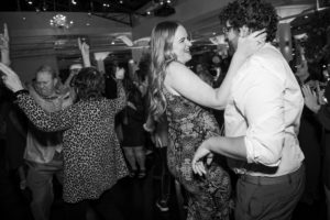 Black and white photo of a couple dancing at a party in New York.