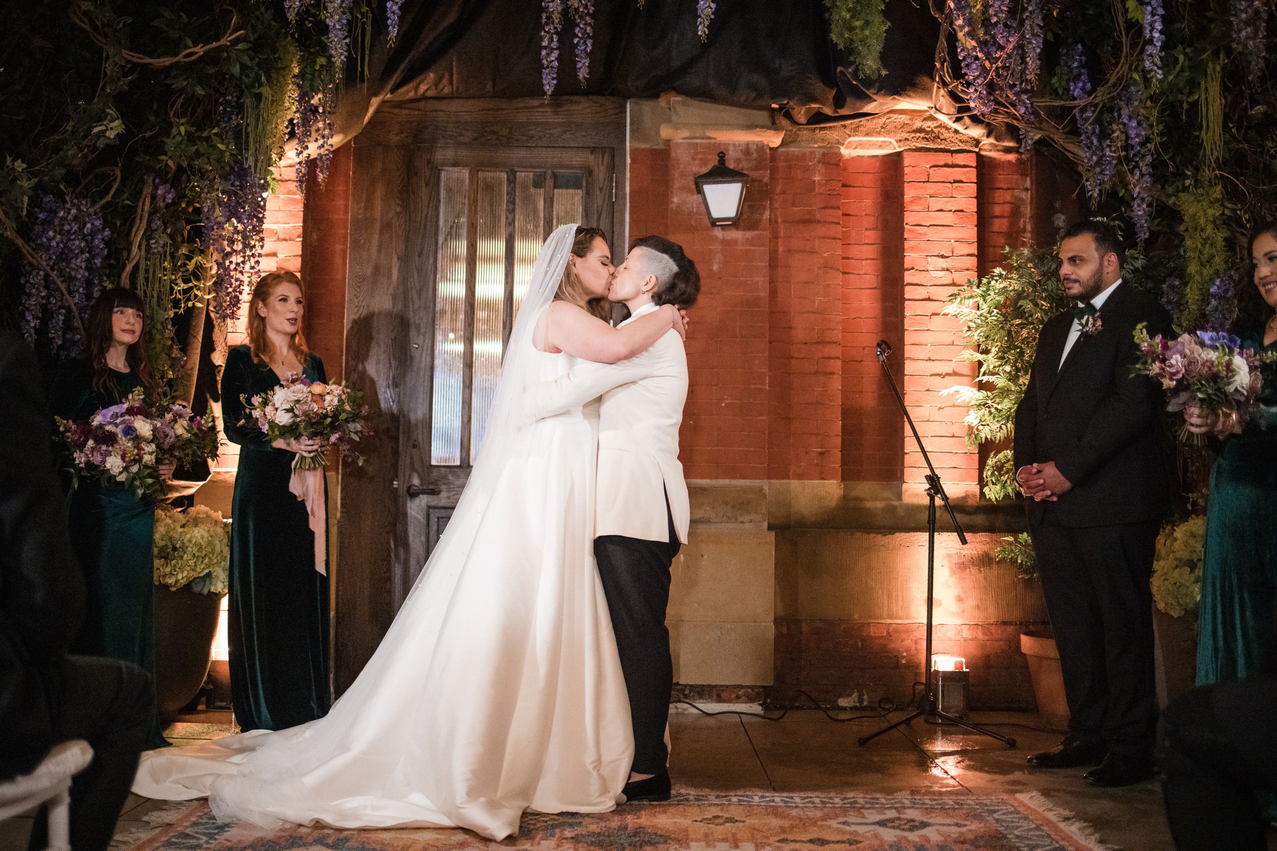 Two brides kiss at a Beekman Hotel wedding in NYC
