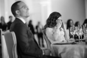 A bride and groom crying at a wedding reception in New York City.