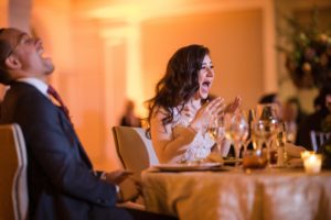 A bride and groom laughing at their New York wedding reception.