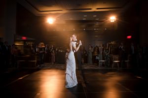 A newlywed couple twirling on the dance floor during their romantic first dance at their elegant wedding reception in New York.