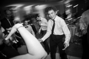 Black and white photo of a man dancing at a wedding in New York.
