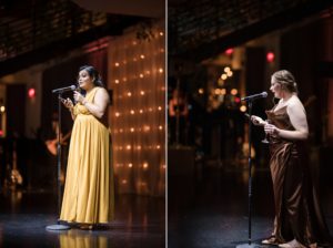 Two women singing into microphones at a New York wedding.