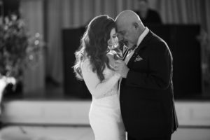 A black and white photo of a bride and her father sharing a dance at their New York wedding.