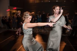 Two bridesmaids dancing at a wedding reception in New York.