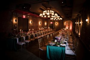 A wedding reception room with tables and chairs set up in New York.