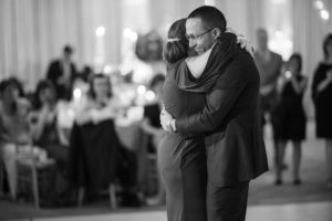 A bride and groom hugging during their wedding in New York.