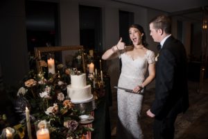 A newly married couple cutting their wedding cake in New York.