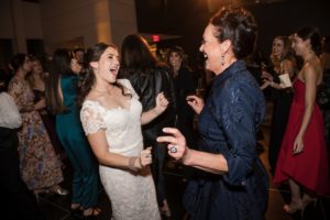 Two women dancing at a wedding in New York.