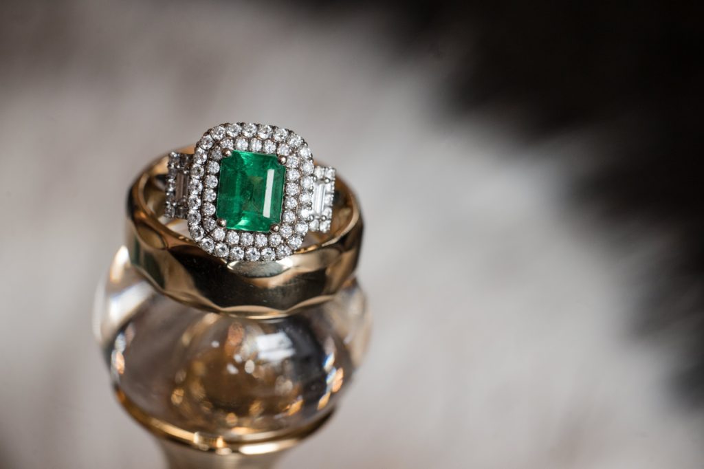 A wedding ring with diamonds and an emerald, purchased in New York.