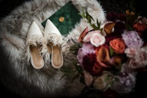 New York wedding shoes and flowers on a fur rug.
