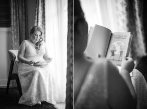 A wedding bride is reading a book in front of a window.