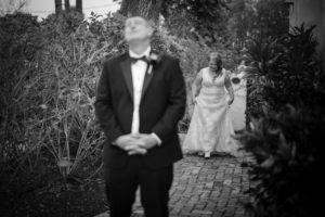 A bride and groom elegantly walking down a path during their New York wedding.