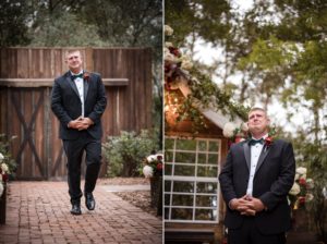 A groom in a tuxedo standing in front of a wooden gate at his wedding.