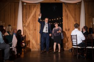 A couple gracefully walking down the aisle at a wedding in New York.