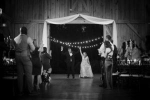 A bride and groom walking down the aisle at a barn wedding in New York.