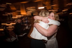 A bride and groom hugging at their New York wedding reception.