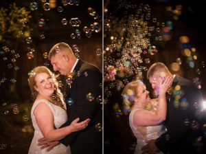 A bride and groom kissing in front of soap bubbles on their wedding day in New York.