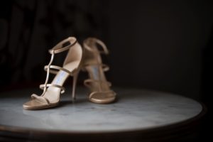 A pair of high heeled wedding shoes sitting on a table in New York.
