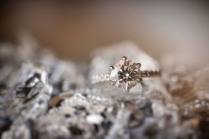 A diamond engagement ring sits on top of a pile of rocks in New York.