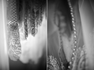 A black and white photo of a wedding dress hanging on a hanger in New York.