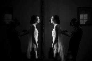 A wedding bride is getting ready in front of a mirror in New York.