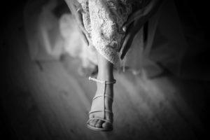 A black and white photo of a bride's feet at her wedding in New York.