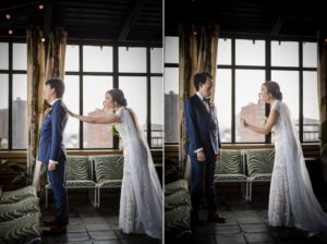 A bride and groom exchanging loving glances in front of a window at their New York wedding.