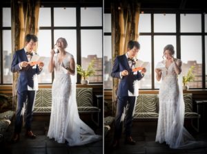 A bride and groom share their vows in front of a window overlooking New York City during their intimate wedding ceremony.
