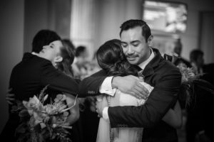 A wedding couple hugging in a black and white photo in New York.