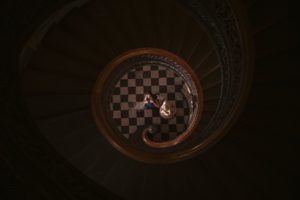 A couple standing on the top of a NEW YORK spiral staircase.