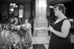 A woman is speaking into a microphone at a wedding in New York.