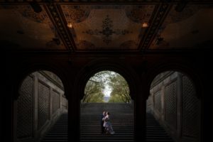 A bride and groom standing on a staircase in Central Park, New York, enjoying their wedding ceremony.