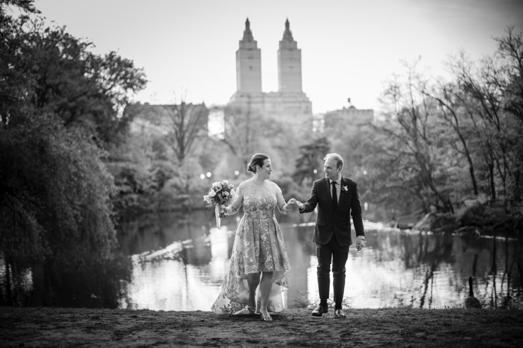 A bride and groom exchange vows in front of a picturesque pond in Central Park, New York.