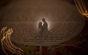 A silhouette of a couple in front of a book, captured during their romantic New York wedding.