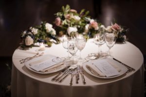A round table with place settings for a New York wedding.