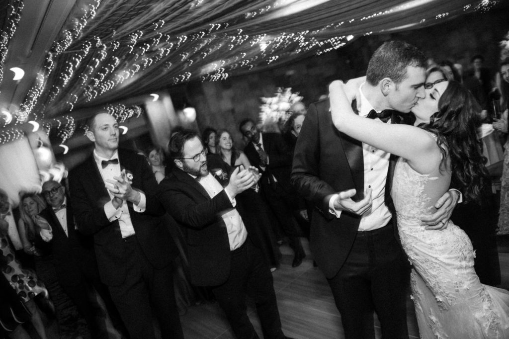A wedding party kisses on the dance floor in New York.