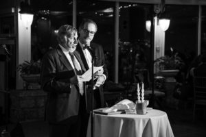 Two men standing at a wedding table with candles in New York.