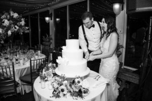 A bride and groom cutting a wedding cake in New York.