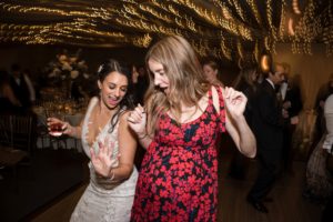 Two women dancing at a wedding reception in New York.