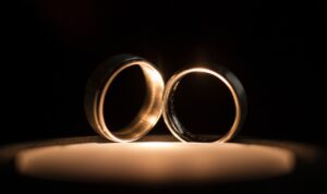 Two wedding rings on top of a candle in New York.