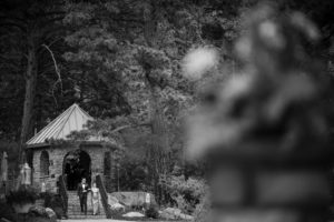 A black and white photo of a couple walking down a path in New York.