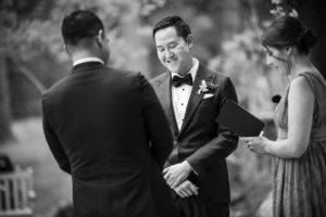 A man in a tuxedo smiles during his wedding ceremony in New York.