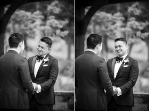 Two men in tuxedos shake hands during their wedding ceremony in New York.