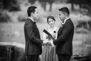 A black and white photo of a couple exchanging vows in New York City.