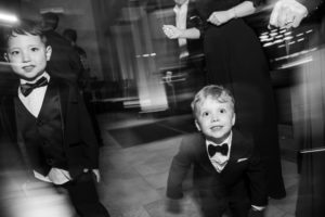 Two little boys in tuxedos attending a wedding in New York.